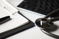 Medical stethoscope on computer keyboard with clipboard and pen Royalty Free Stock Photo