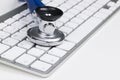 Medical stethoscope on computer keyboard. Concept of computer support. Royalty Free Stock Photo