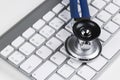 Medical stethoscope on computer keyboard. Concept of computer support. Royalty Free Stock Photo