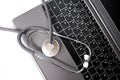 Medical stethoscope, the doctor`s tool lies on the laptop keyboard, the concept of a physician`s workplace, checking the health Royalty Free Stock Photo