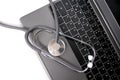 Medical stethoscope, the doctor`s tool lies on the laptop keyboard, the concept of a physician`s workplace, checking the health Royalty Free Stock Photo