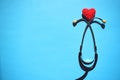 Medical stethoscope head and red heart on blue background. heart disease, rate measure, Cardio therapeutist, arrhythmia concept