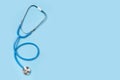 Medical stethoscope isolated on blue background. stethoscope is an important diagnostic tool for doctor. copy space. Flat lay, top Royalty Free Stock Photo