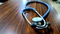 a blue stethoscope on a brown patterned table