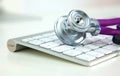 Medical stethoscope lies on a computer keyboard Royalty Free Stock Photo