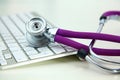 Medical stethoscope lies on a computer keyboard Royalty Free Stock Photo