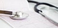 stethoscope lying on cardiogram chart closeup. Medical help, prophylaxis, disease prevention or insurance concept. Royalty Free Stock Photo