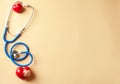 Medical stethoscope and red hearts on light background. Cardiology concept