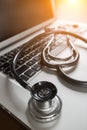 Medical Stethoscope Resting on Laptop Computer Keyboard. Royalty Free Stock Photo