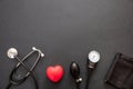 Medical stethoscope and sphygmomanometer on black background, top view Royalty Free Stock Photo