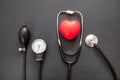 Medical stethoscope and sphygmomanometer on black background, top view Royalty Free Stock Photo