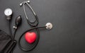 Medical stethoscope and sphygmomanometer on black background, top view Royalty Free Stock Photo