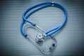 Medical stethoscope on striped background top view Royalty Free Stock Photo