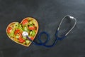 Medical stethoscope touching fresh healthy food Royalty Free Stock Photo