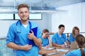 Medical student with groupmates in library Royalty Free Stock Photo