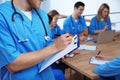 Medical student with groupmates in library