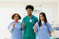 Medical student man and woman thumbs up group students on background in classroom hospital medical school. Royalty Free Stock Photo