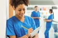 Medical student taking notes in hallway Royalty Free Stock Photo