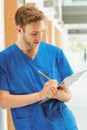 Medical student taking notes in hallway Royalty Free Stock Photo
