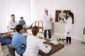 Medical students and professor studying human skeleton anatomy Royalty Free Stock Photo