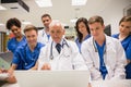 Medical students and professor using laptop Royalty Free Stock Photo