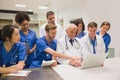 Medical students and professor using laptop Royalty Free Stock Photo