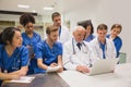 Medical students and professor using laptop Royalty Free Stock Photo