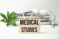 medical studies words on the wooden blocks and stethoscope