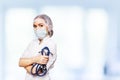 Medical surgeon doctor woman over blue clinic background. With place for medical advertise. Medical advertising concept. Royalty Free Stock Photo