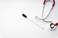 Medical swab and stethoscope on white background