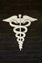 Medical Symbol or Emblem on Dark Brick Wall