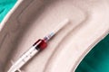 Medical syringe, bloodsample lying in a one use capsule