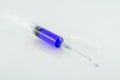Medical syringe with drop on white