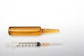 Medical syringe and drug ampule on white floor in overuse and abuse of addiction of antibiotics or crack Royalty Free Stock Photo