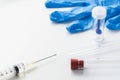 Medical syringe, glass tubes, stool test sampler and blue latex glove on white Royalty Free Stock Photo