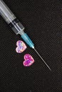 Medical Syringe and a Heart. Heart shaped object and a Cure.