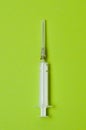 Medical syringe isolated on a green background