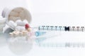 Medical syringe with medicine pill. Royalty Free Stock Photo