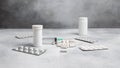 medical syringe, medicine pills, capsules, vials on grey concrete background Royalty Free Stock Photo