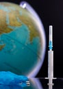 Medical syringe, pills, glove on a background of the globe. Coronavirus 2020. Virus, bacterium. Global epidemic. Viral Vaccine Sea
