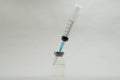 A medical syringe recruits a vaccine from an ampoule