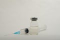 A medical syringe recruits a vaccine from an ampoule