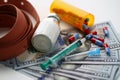 Medical syringe with white cocaine powder and medical pills on dollar bills Royalty Free Stock Photo