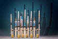 Medical syringes and glass vials of vaccine on a blue background with a shadow. The concept of vaccination of the population
