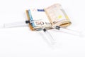 Medical syringes on wad of several euro banknotes bills Royalty Free Stock Photo