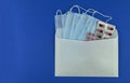 medical tablets in an envelope on a blue background, isolates, Royalty Free Stock Photo