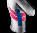 Medical taping for thorax pain relief, rib fractures showed on young model.