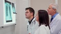 Medical team analizes x-ray on x-ray view box