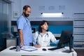 Medical team analyzing computer screen for checkup information