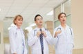 Medical team discussing in the corridor at hospital, team of mixed-races doctors, Group of multi ethnic medics, men and women Royalty Free Stock Photo